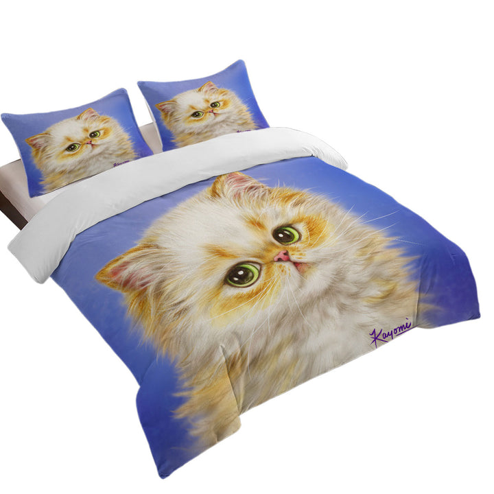 Adorable Ginger Kitten over Purple Bed Covers