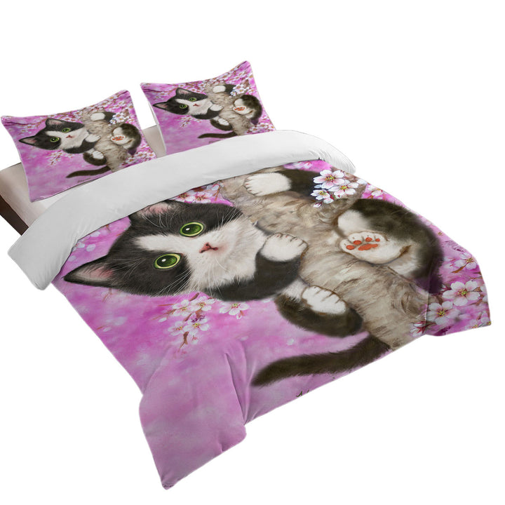 Cute Black and White Kitten Cat on Cherry Blossom Bed Covers