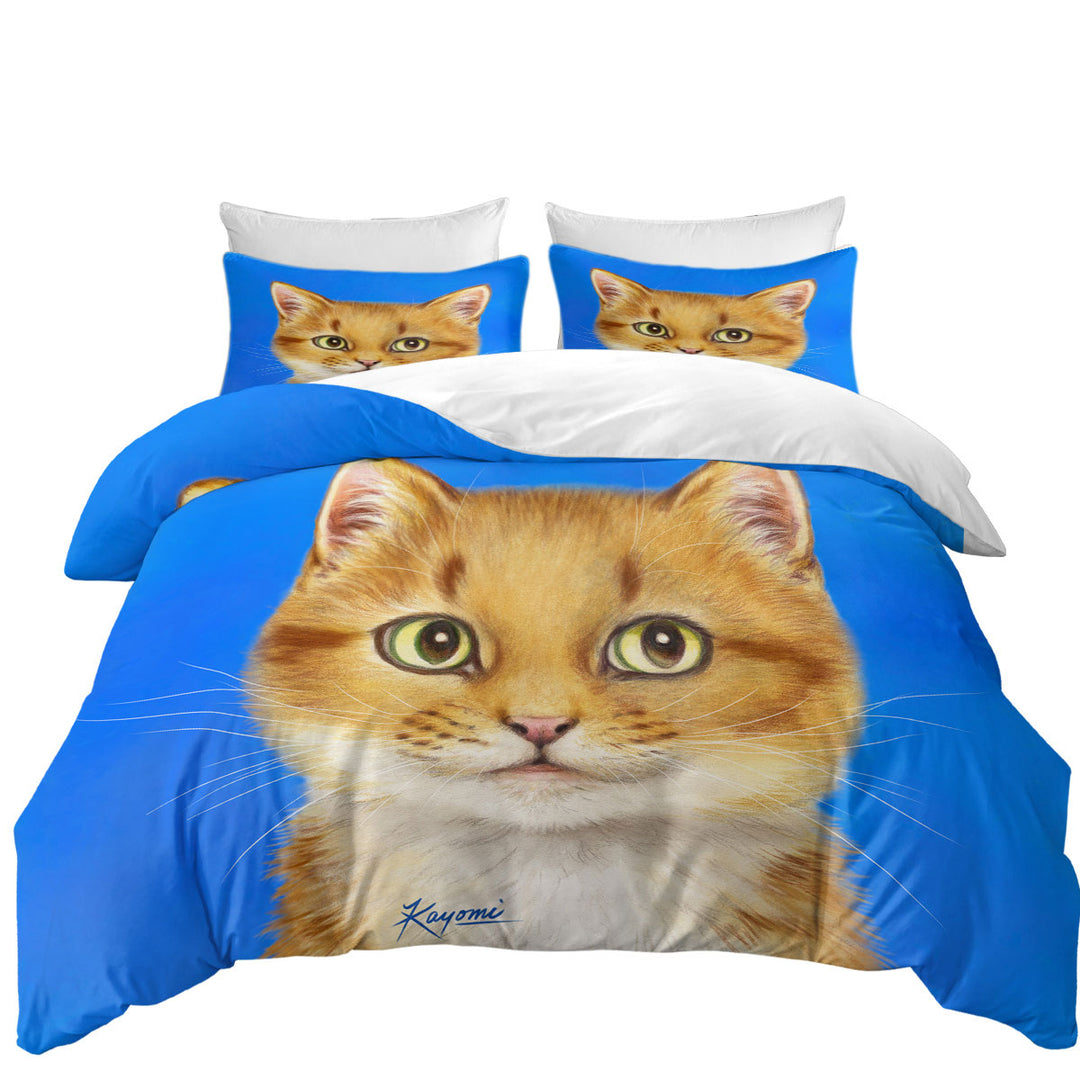 Handsome Ginger Cat over Blue Bed Covers