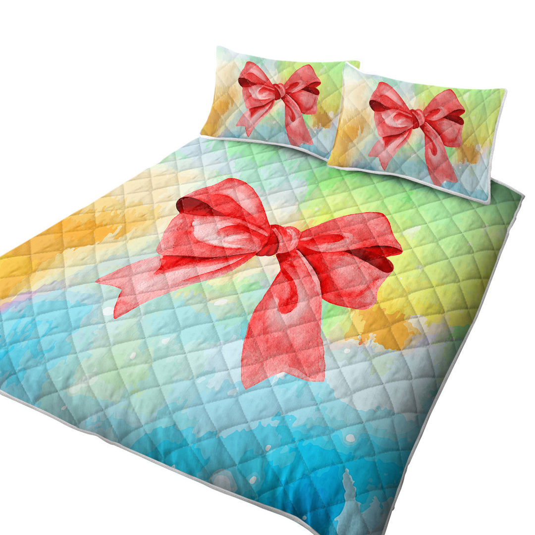 King Quilt with Red Ribbon over Pastel Colors