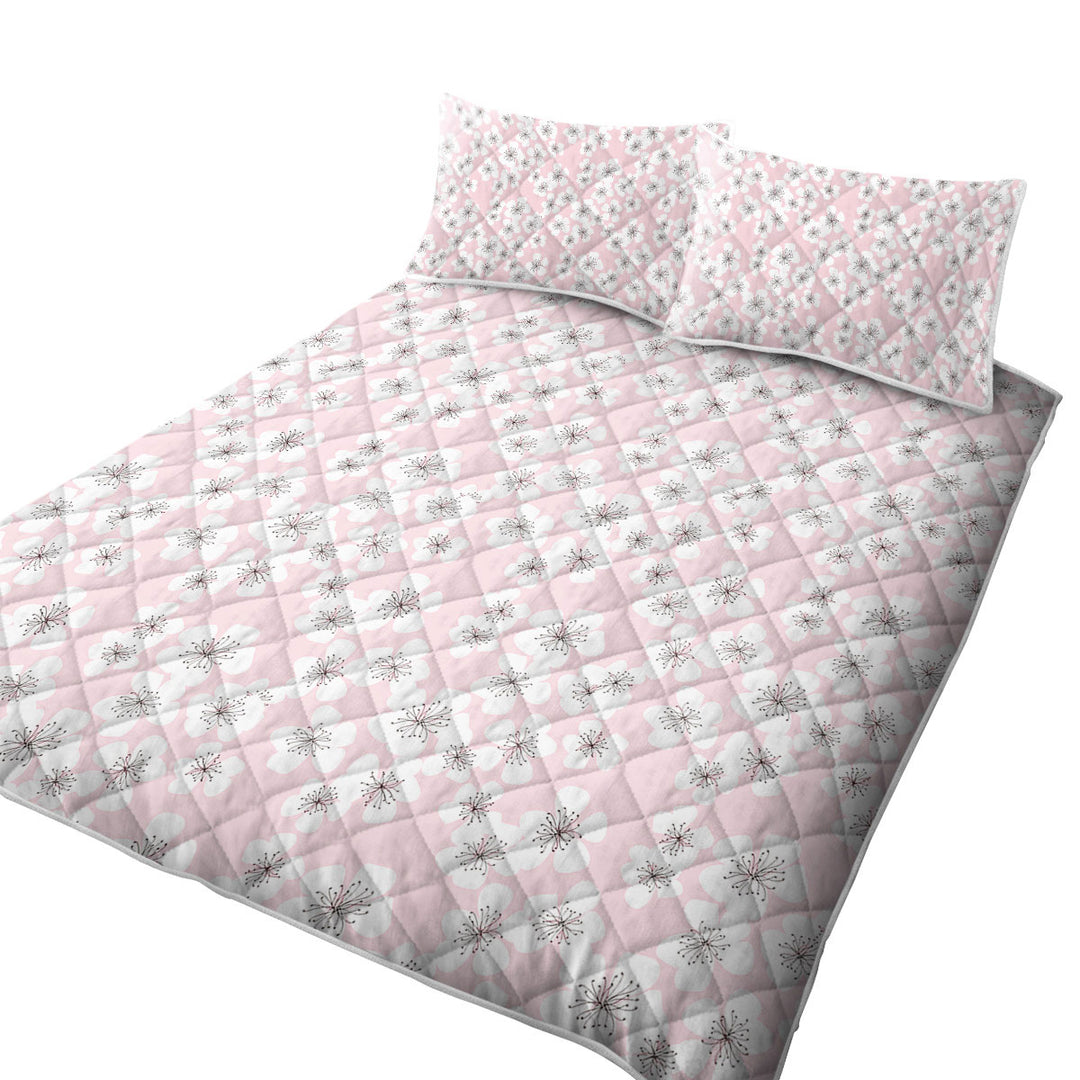 White Floral Drawings over Pink Coverlet