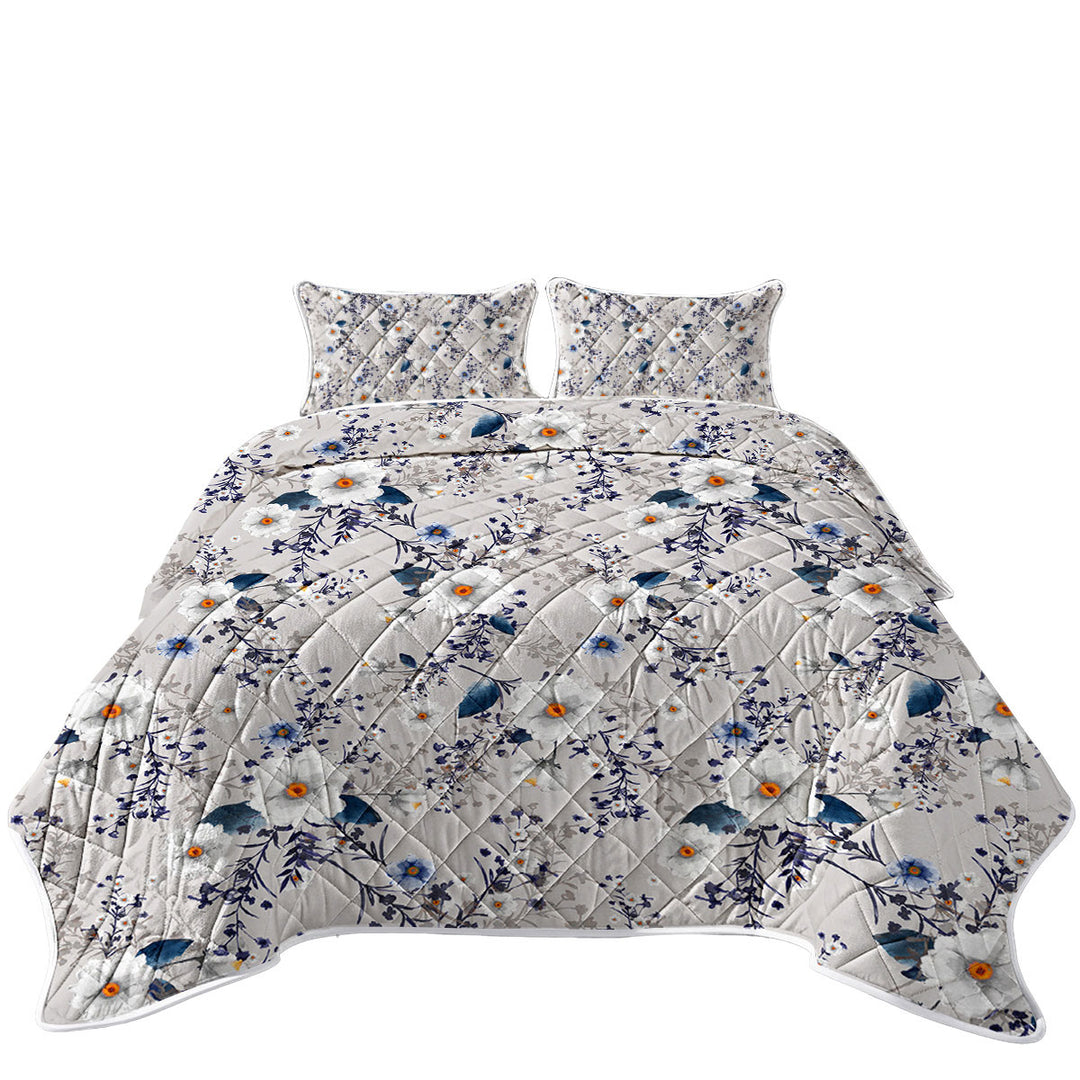 White and Blue Flowers over Grey Quilt