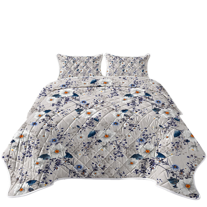 White and Blue Flowers over Grey Quilt