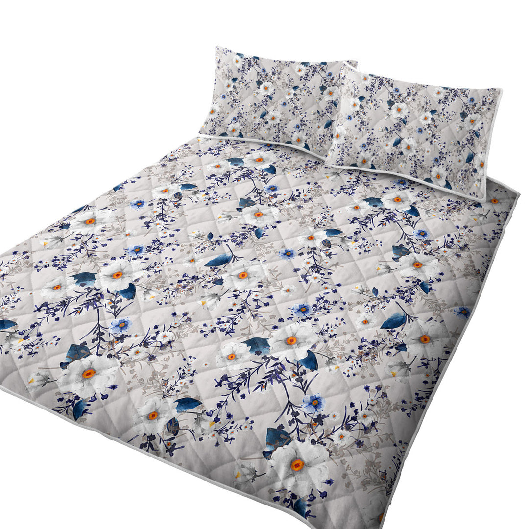 White and Blue Flowers over Grey Quilts