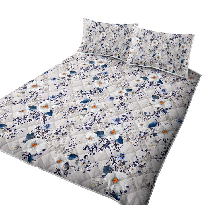 White and Blue Flowers over Grey Quilts