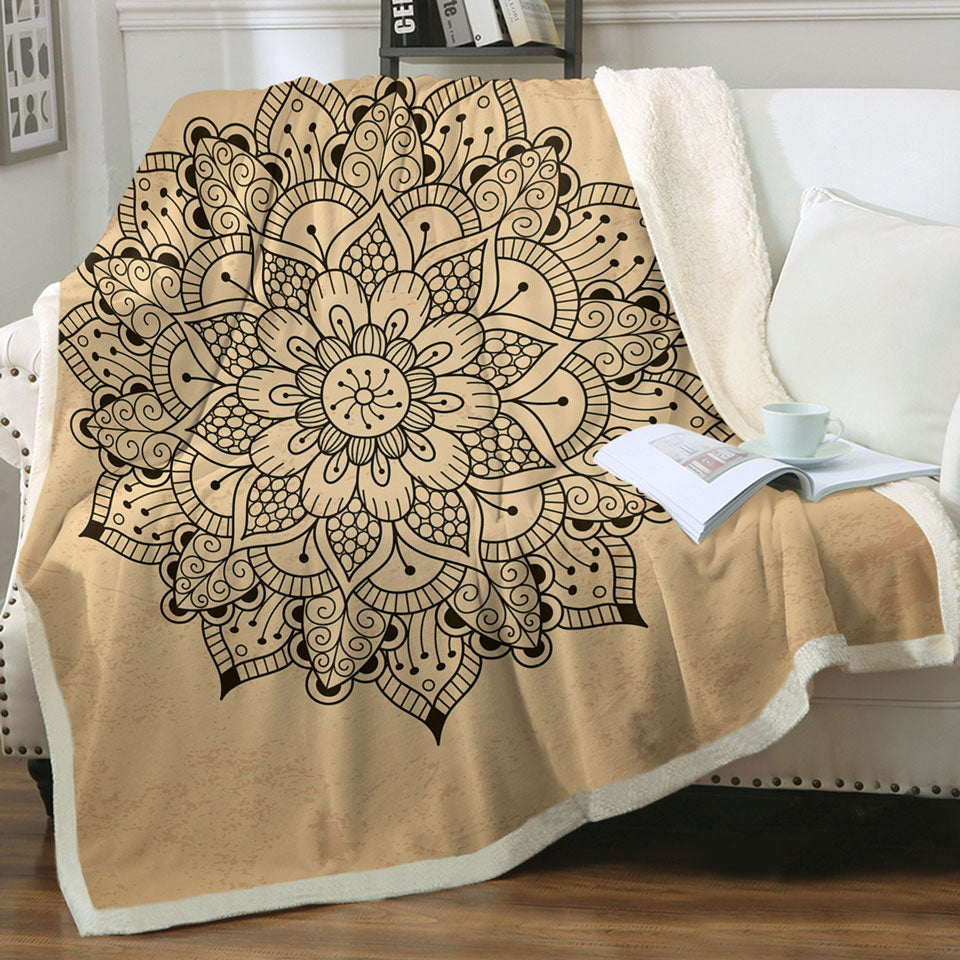 Black Mandala Throw Blanket over Light Tan