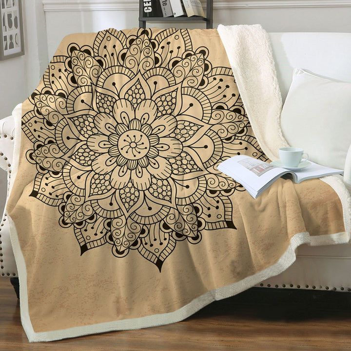 Black Mandala Throw Blanket over Light Tan