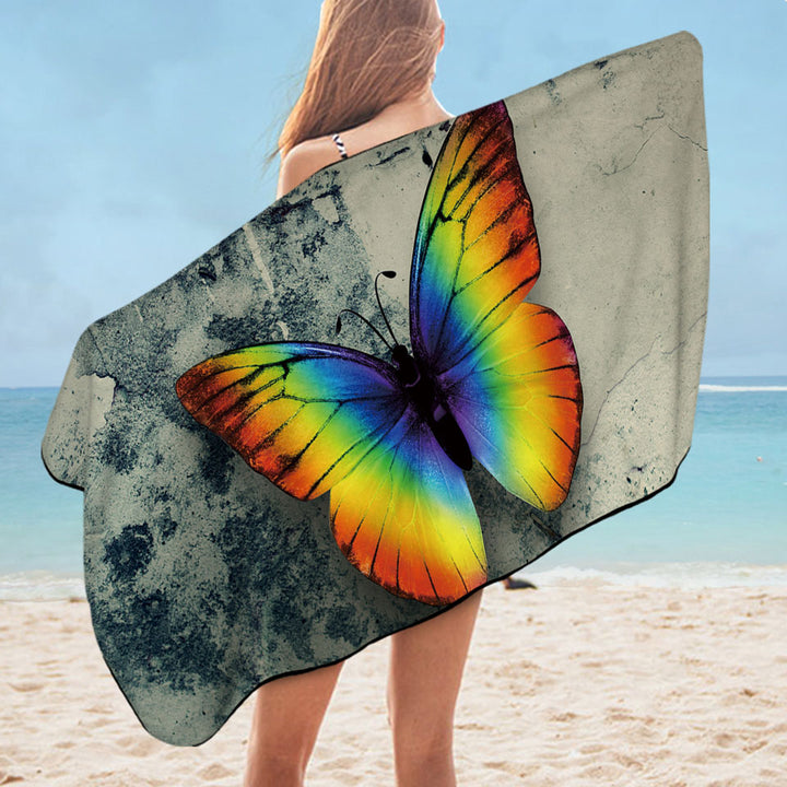 Rainbow Pool Towels with Butterfly Over Concrete